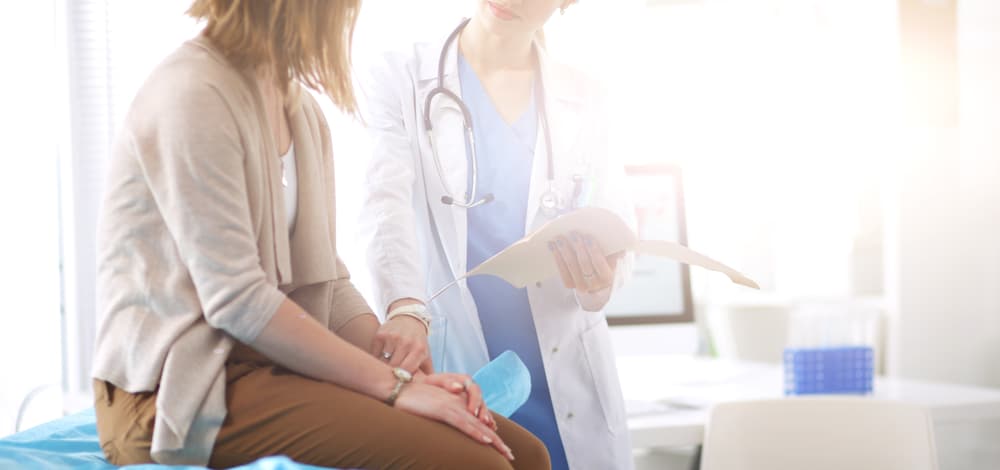 Doctor,And,Patient,Discussing,Something,While,Sitting,At,The,Table