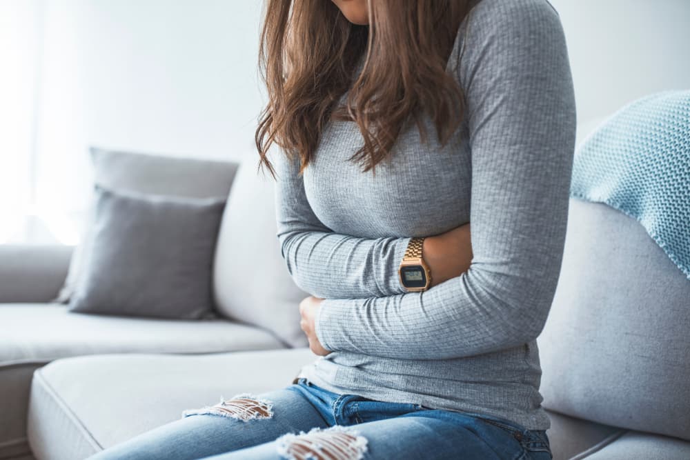 Woman,Lying,On,Sofa,Looking,Sick,In,The,Living,Room.