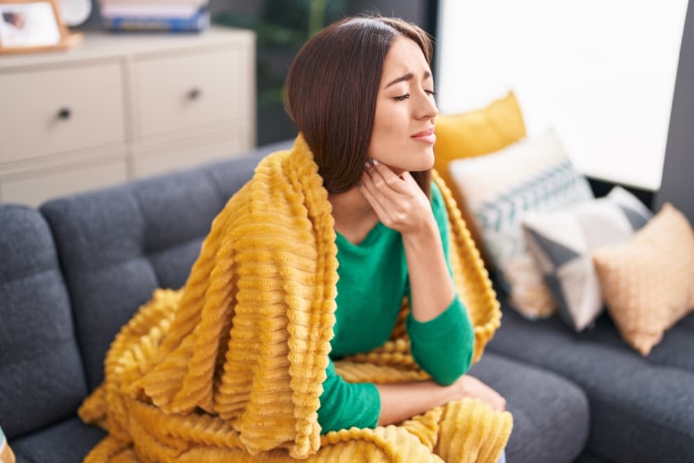 Young,Beautiful,Hispanic,Woman,Suffering,For,Throat,Pain,Sitting,On