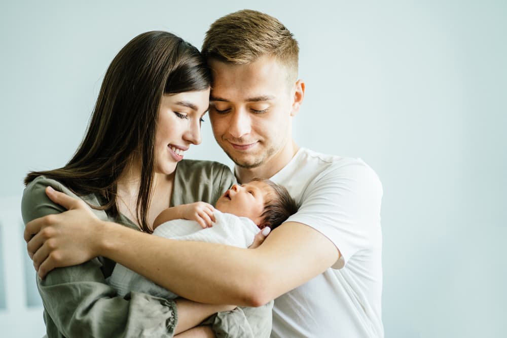 Portrait,Of,Happy,Loving,Family,At,Home,,Young,Parents,Hugging