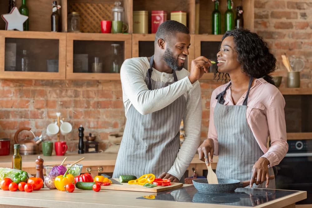 Black,Young,Man,Feeding,His,Beautiful,Woman,While,Cooking,Together