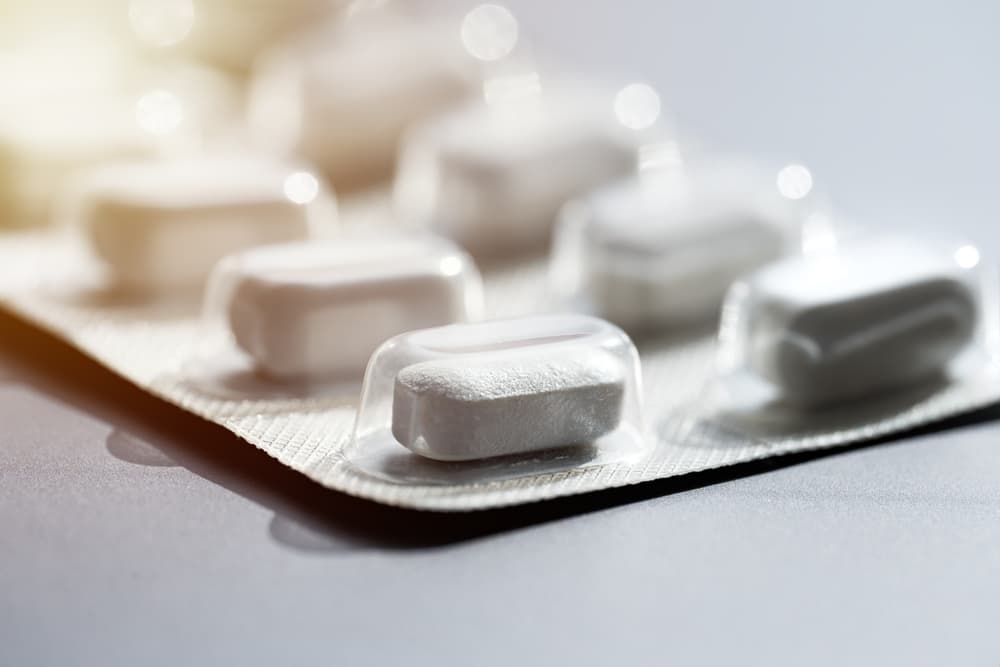 Cartela de medicamento metronidazol sobre uma superfície branca