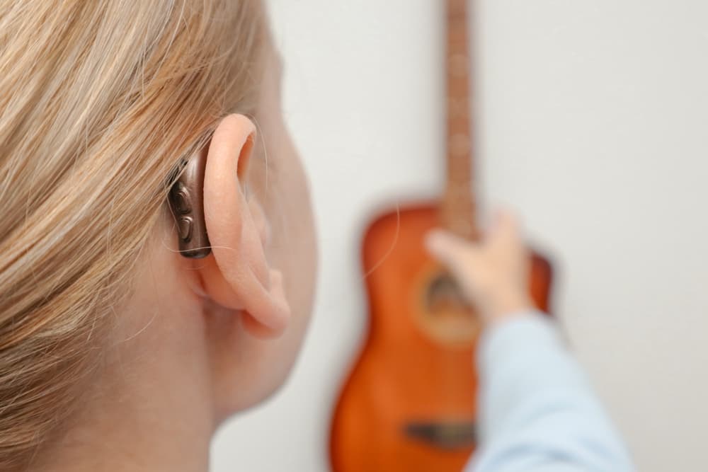 A,Woman,With,Hearing,Loss,Can,Hear,And,Play,Guitar