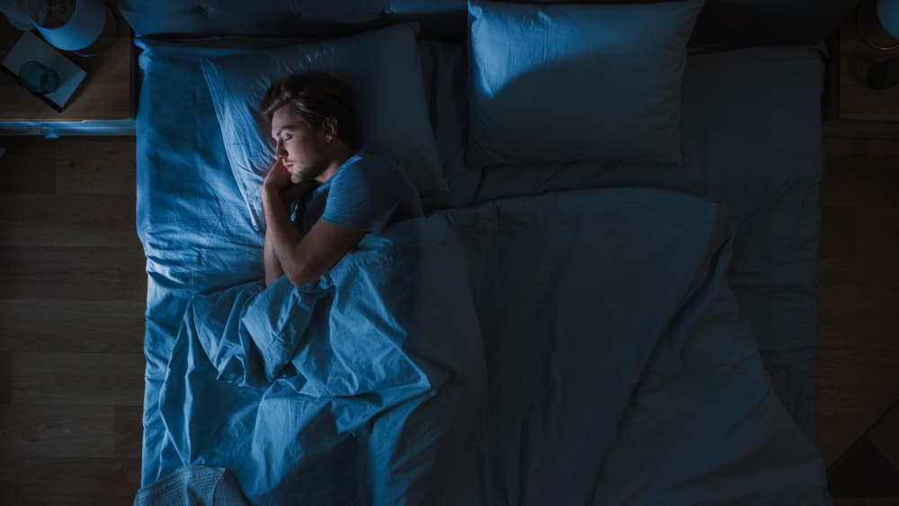 Top,View,Of,Handsome,Young,Man,Sleeping,Cozily,On,A