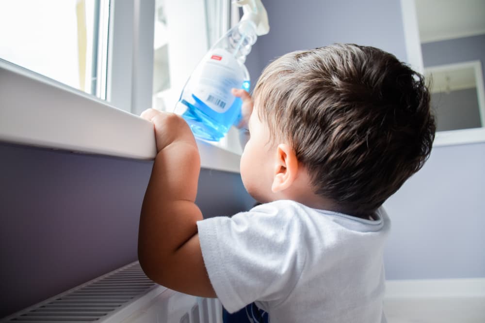 Little,Latin,Boy,Reaching,A,Toxic,Cleaning,Product.