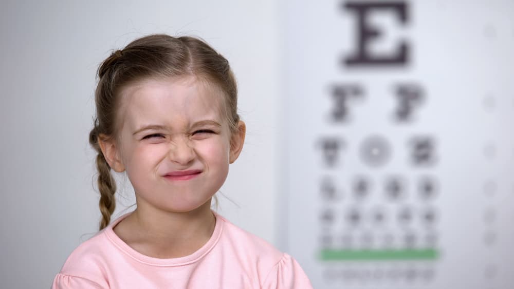 Cute,Girl,Screwing,Up,Her,Eyes,,Trying,To,See,Letters
