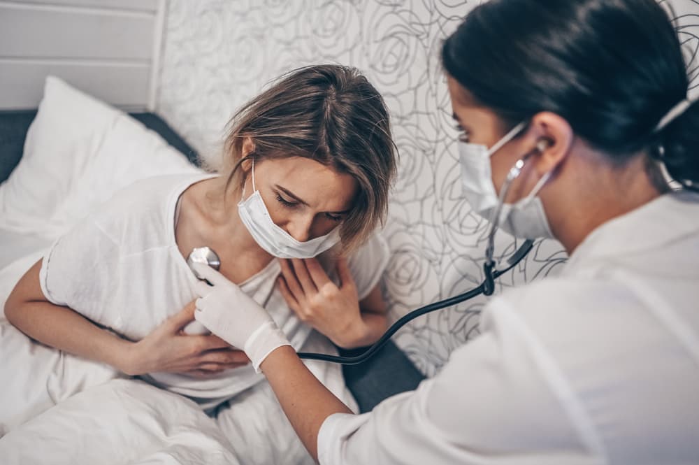 Doctor,Nurse,In,Protective,Face,Mask,Listening,To,Breath,With