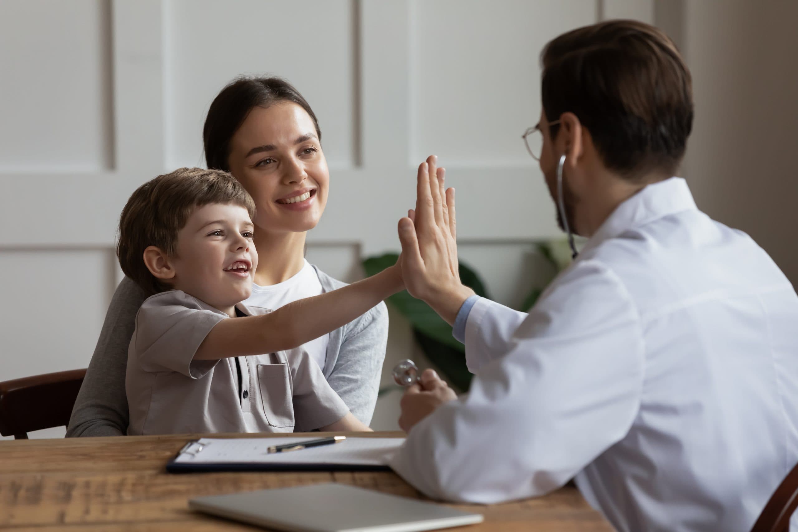 Overjoyed,Small,Boy,Patient,With,Young,Mom,Visit,Male,Doctor