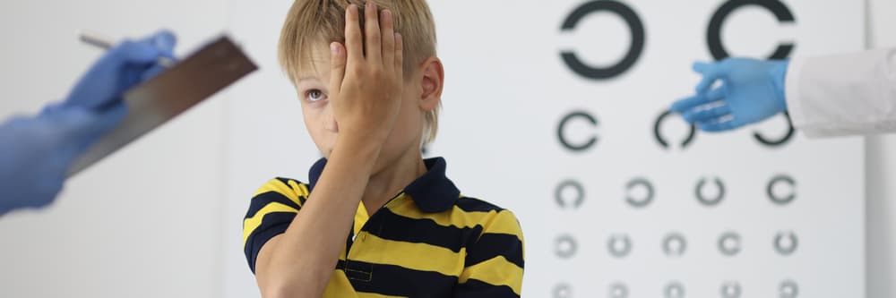 Boy,At,An,Ophthalmologist's,Appointment,Closes,One,Eye,And,Answers