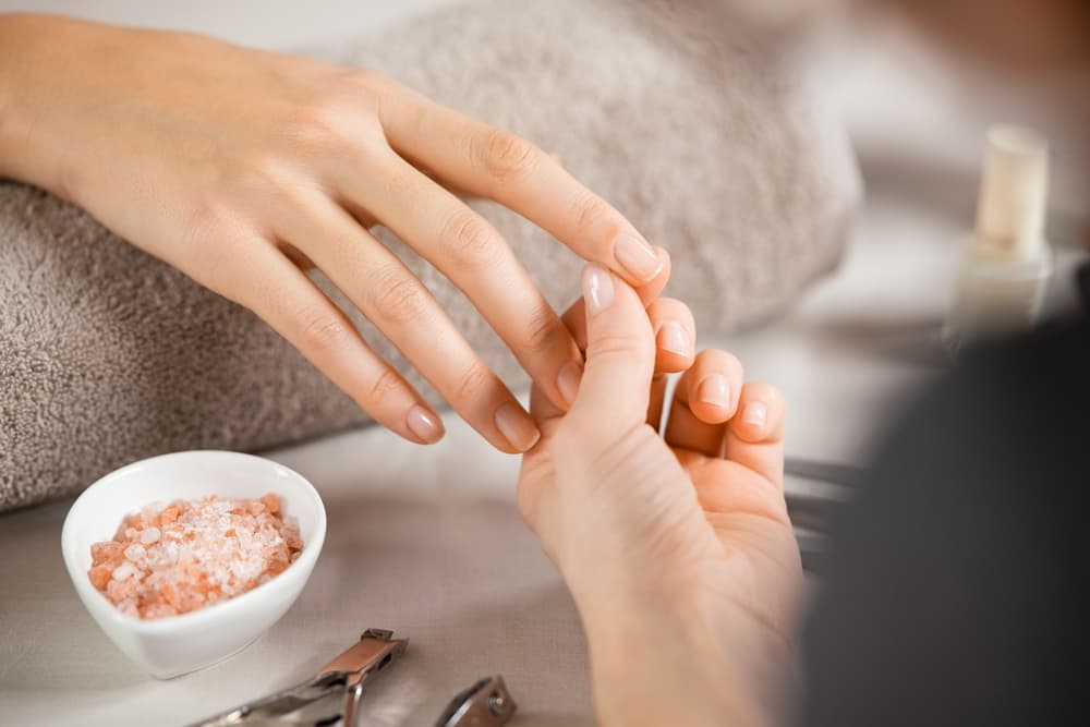 Close,Up,Of,Beautician,Hands,Doing,Hand,Treatment,At,Nail
